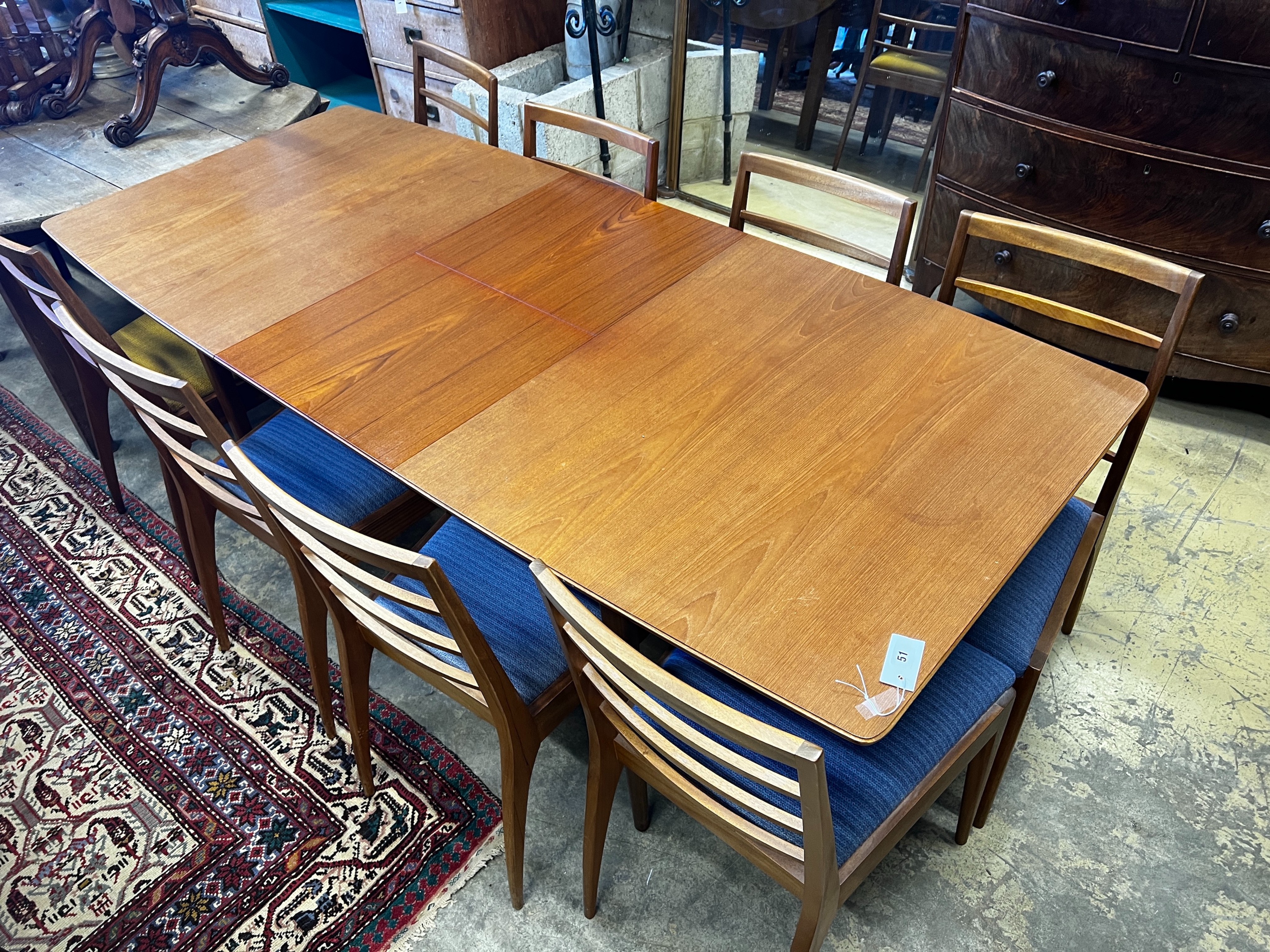 A. H. McIntosh & Co. a Dunvegan teak extending dining table and eight chairs designed by Tom Robertson, table length 193cm extended, depth 83cm, height 74cm